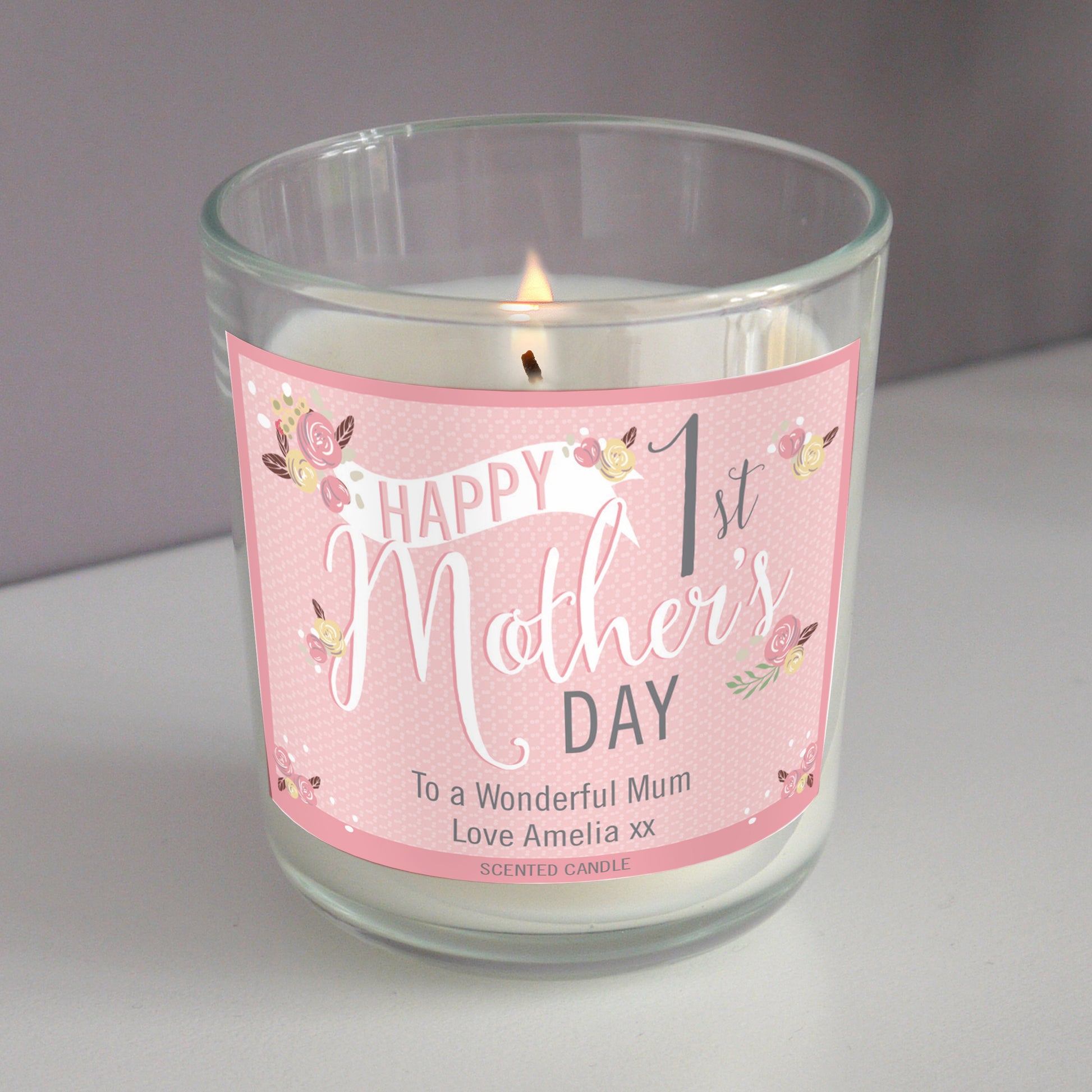 Personalised 1st Mother's Day Scented Candle in clear glass jar with pink label and personal message.