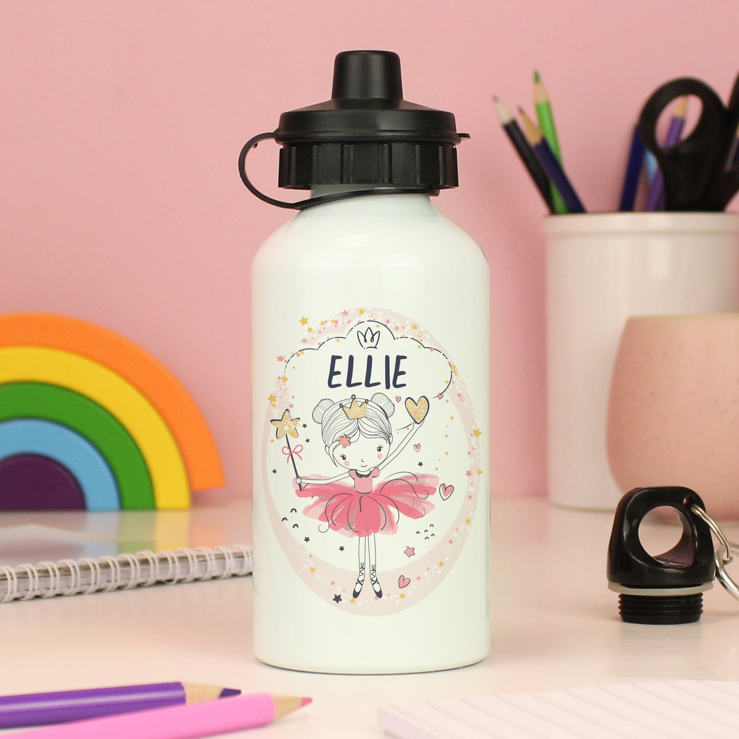 White water bottle with a cartoon character and 'ELLIE' text, placed on a desk with stationery items.