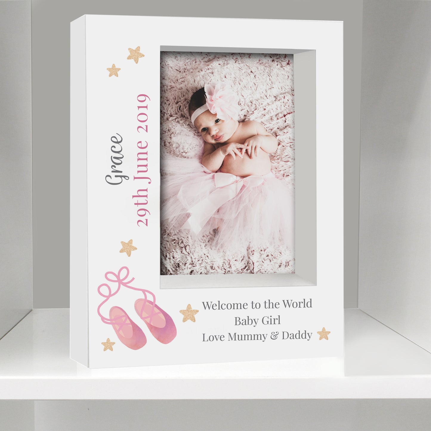 White photo frame with a baby girl's photo and personalized text on a gray background