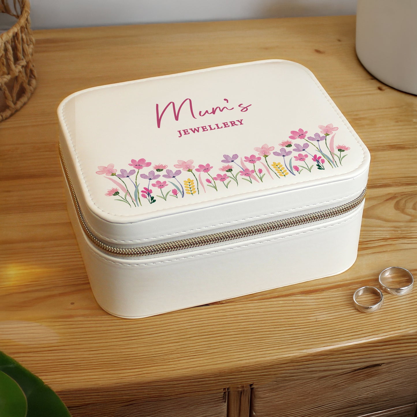 White jewelry box with floral design and 'Mum's Jewellery' text on a wooden surface.