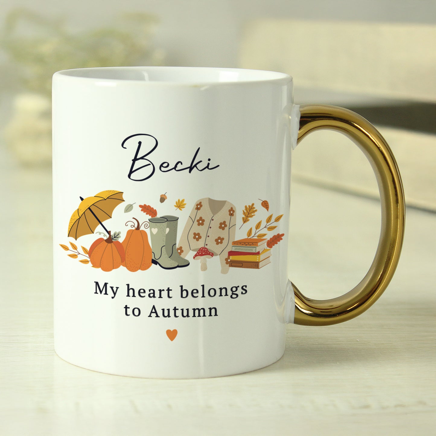 White mug with autumn-themed design and text on a light background