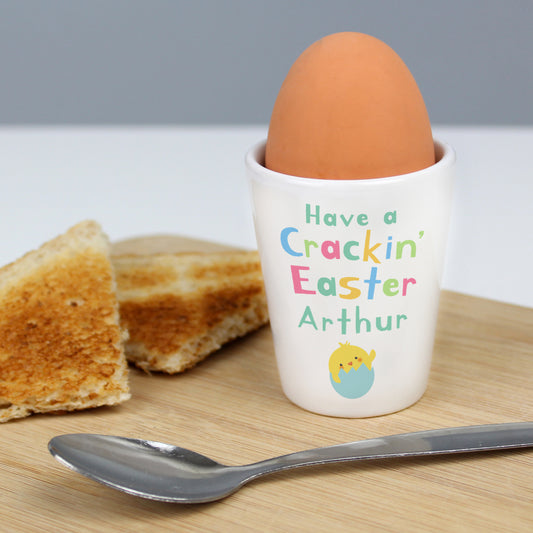 Personalised Easter Egg Cup showing  white egg cup with colourful text - Have a Crackin' Easter Arthur.