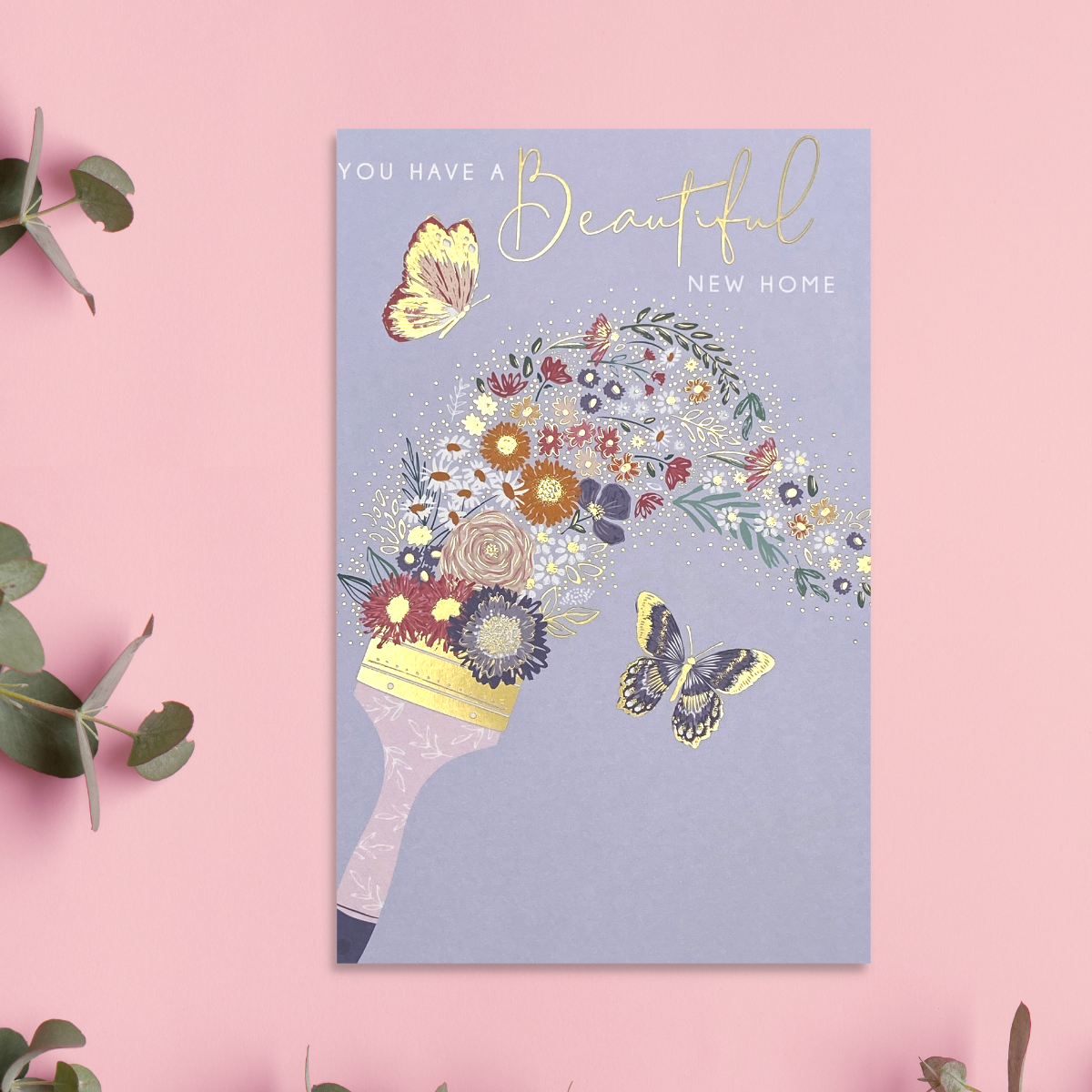 Lilac card with gold paintbrush painting flowerrs with butterflyng floral streak.