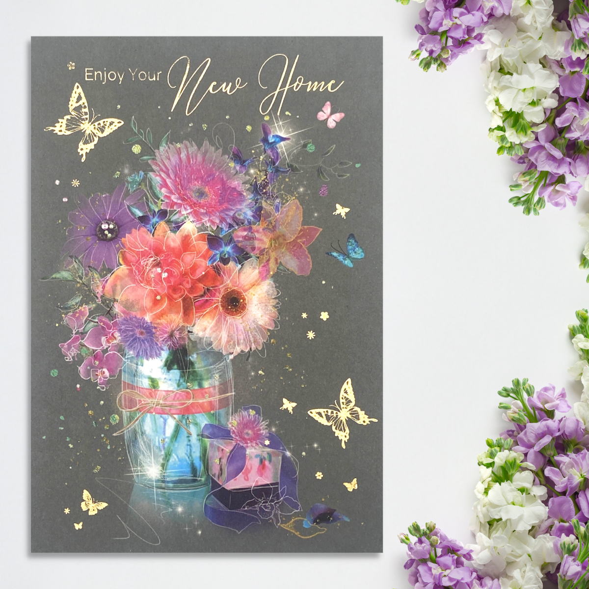 front image with vase of flowers and gift surrounded by butterflies