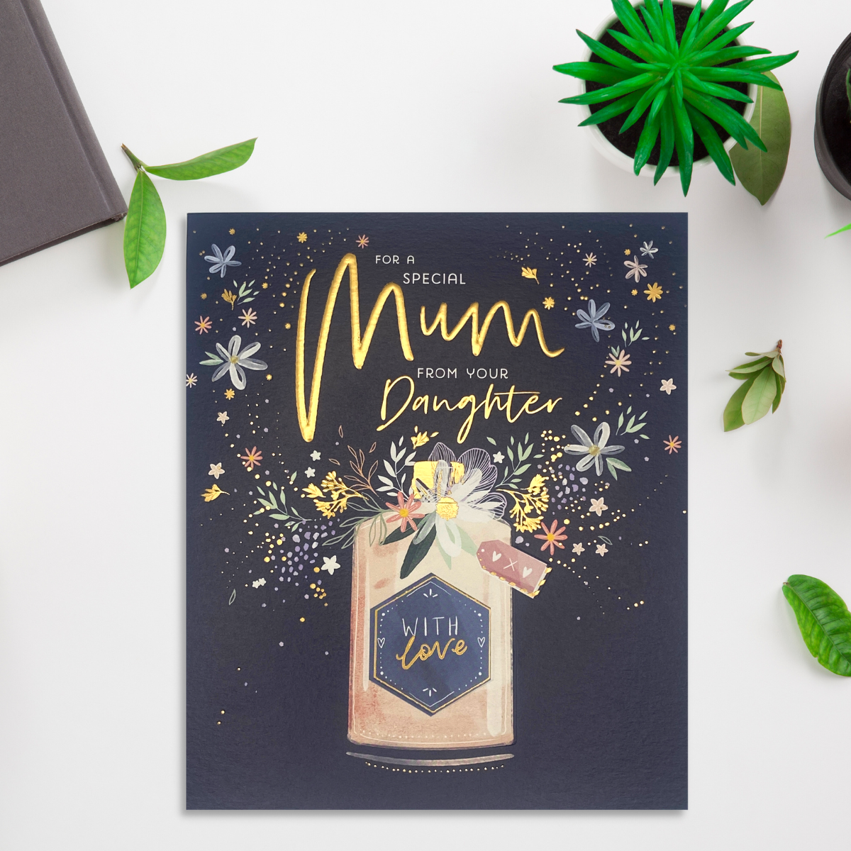 Square navy card with pink floral perfume bottle and gold foil text