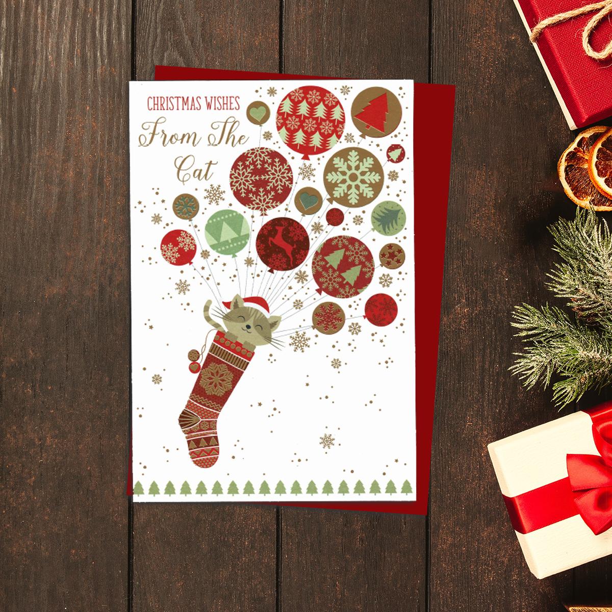 Christmas Wishes From The Cat Card Showing A Cat Peeking from A Christmas Stocking, Floating On An Array Of Balloons