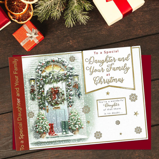 To A Special Daughter And Your Family At Christmas. Showing A Festive Scene Of Decorated Front Door. Lettering And Snowflakes In Gold Foil. Finished With A Red Envelope