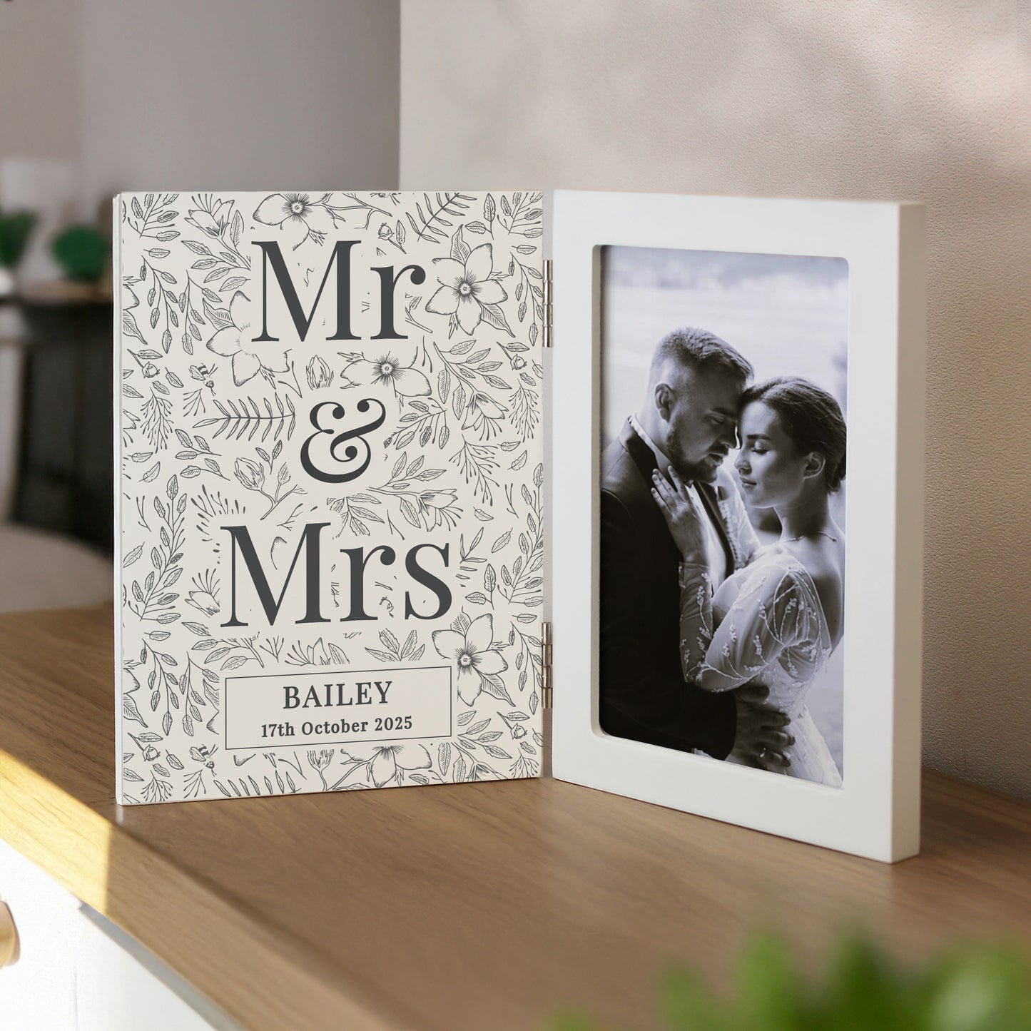 Personalised photo album with 'Mr & Mrs' design on a wooden shelf.