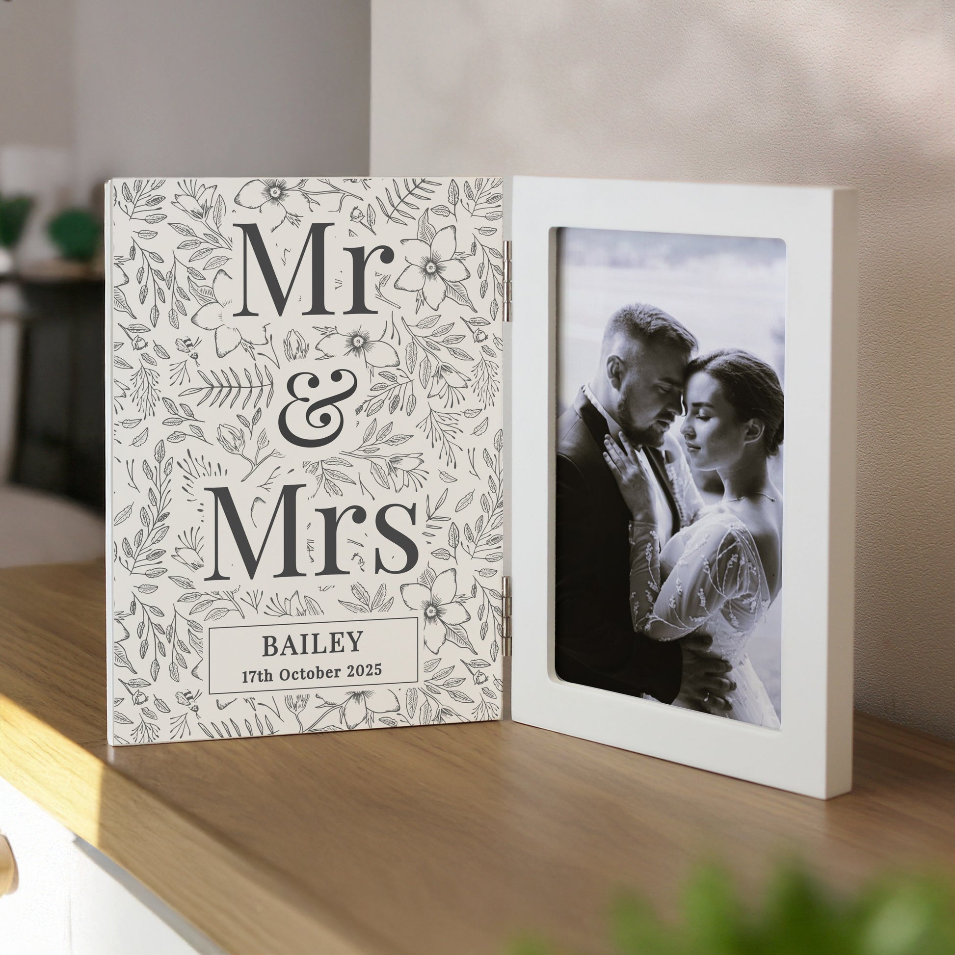 Personalised photo album with 'Mr & Mrs' design on a wooden shelf.