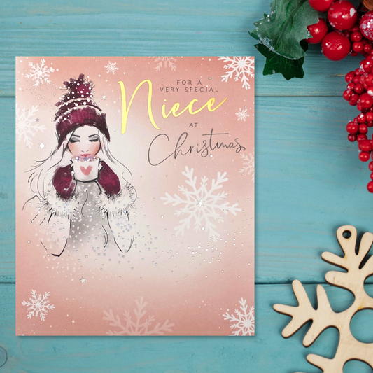 Peach square card with girl in hat and gloves with hot chocolate