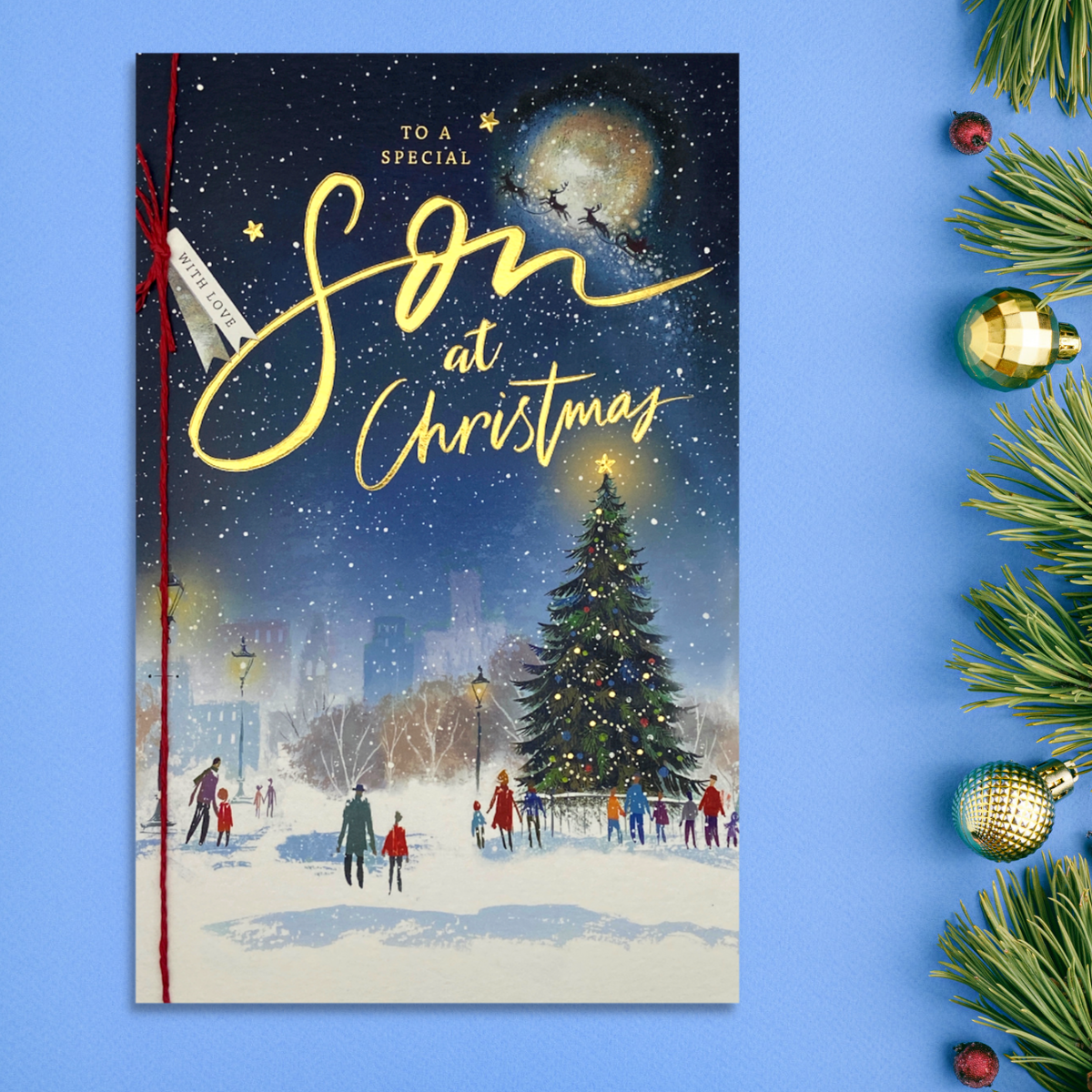 Front image with Christmas snow scene with gold foil text and red ribbon