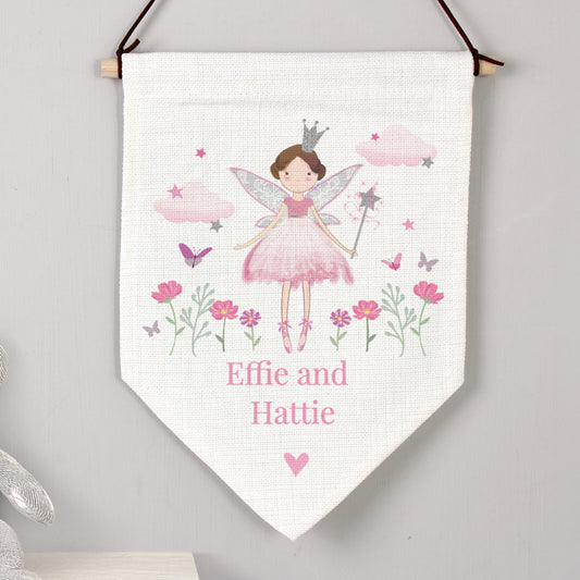 Fairy-themed decorative banner with flowers and butterflies on a white background, hanging against a gray wall.