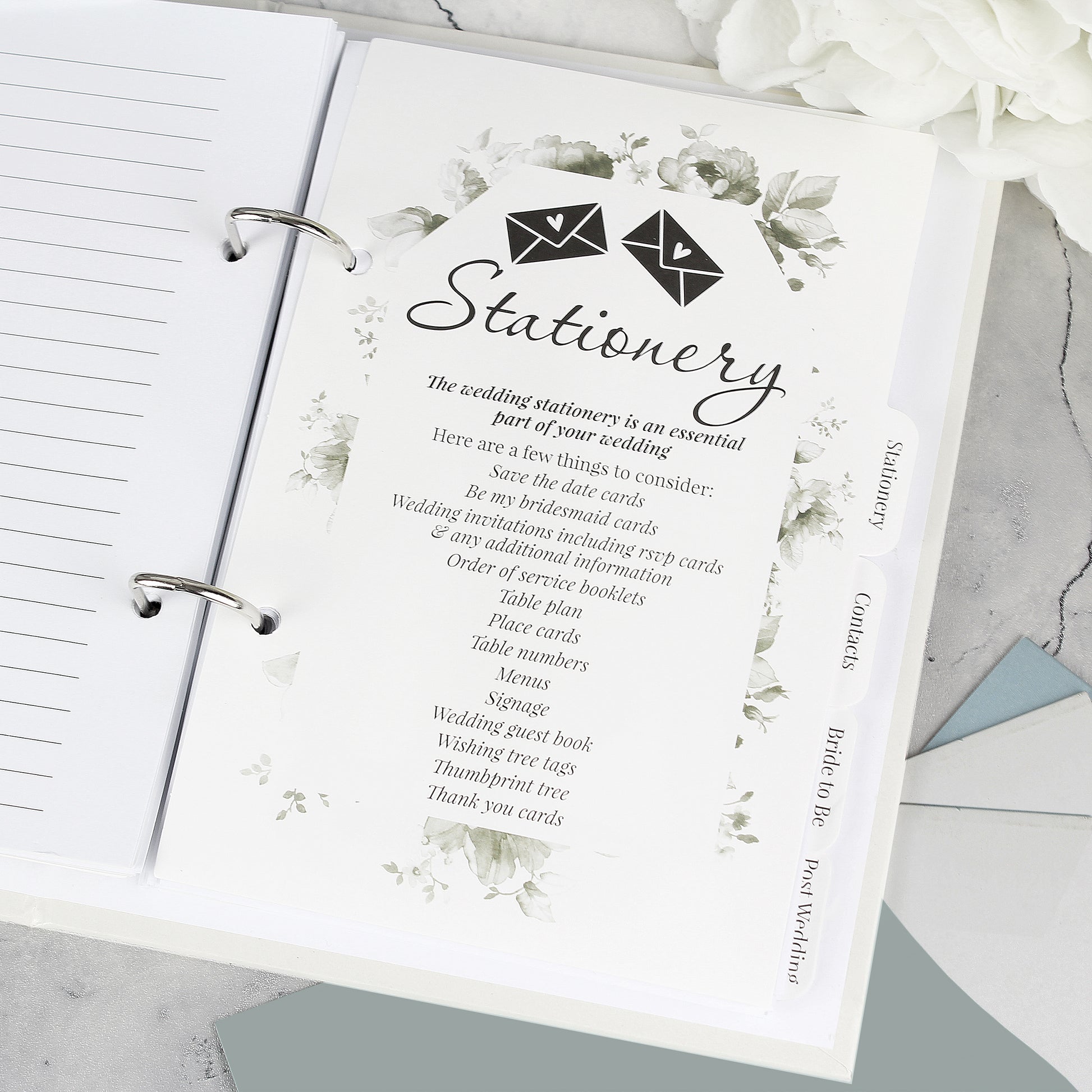 Stationery planner with floral design and text on a marble surface