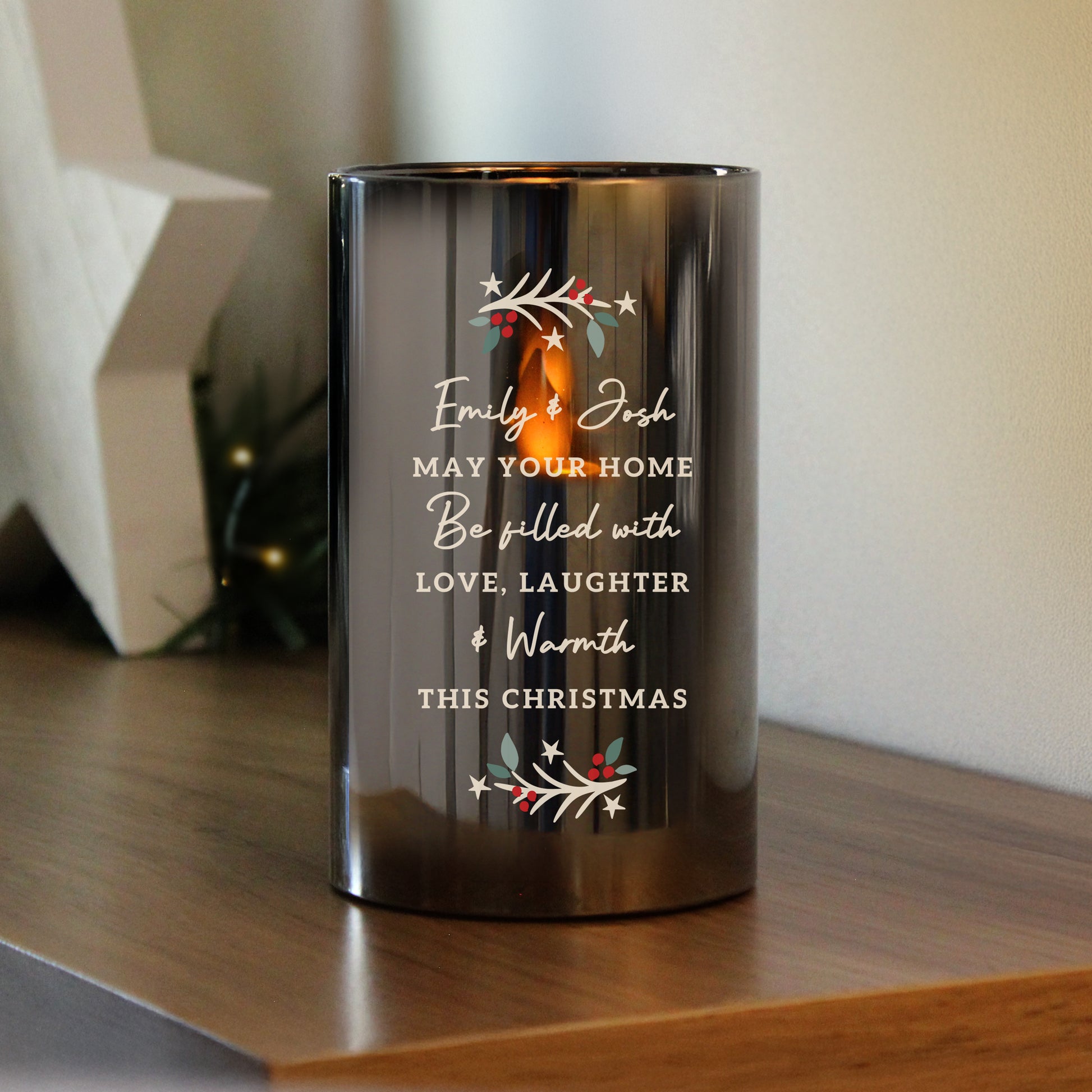 Smoked glass LED candle shown on a wooden shelf. Text reads Emily & Josh May Your Home be filled with Love, Laughter & Warmth This Christmas