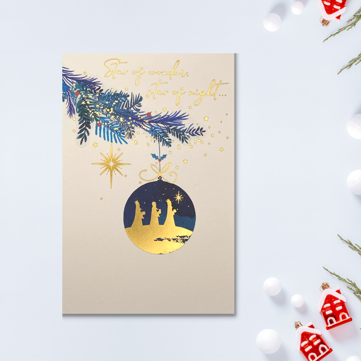 Cream card with bauble  hanging with three kings inside and gold text