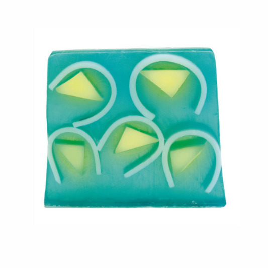 Green soap slice with yellow triangles and white swirls within