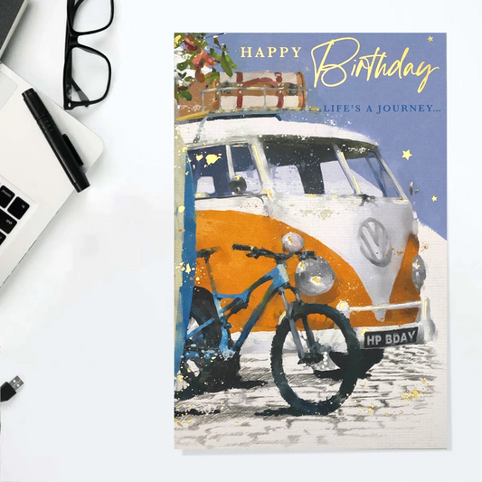 Orange and white campervan with mountain bike and suitcase