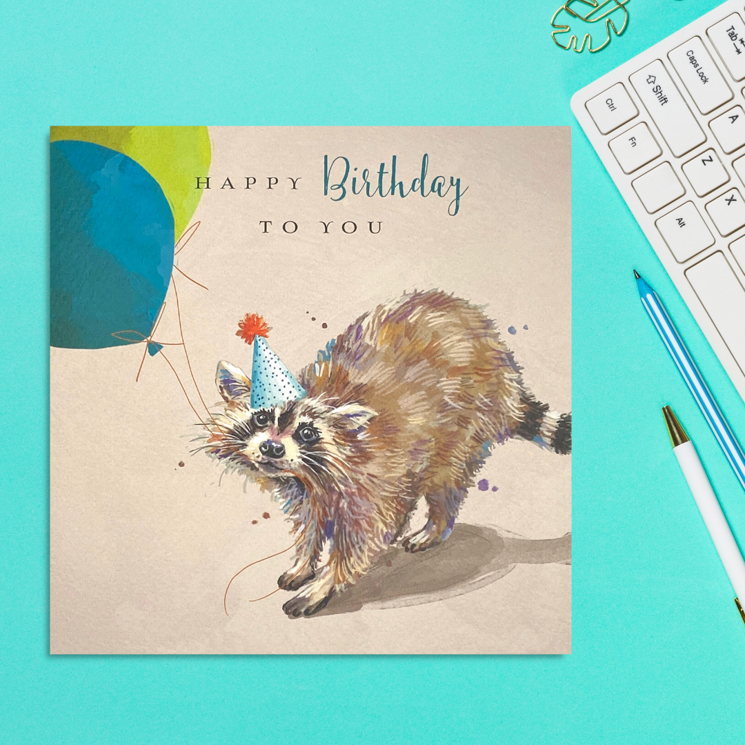 Square card featuring a raccoon in party hat and balloons