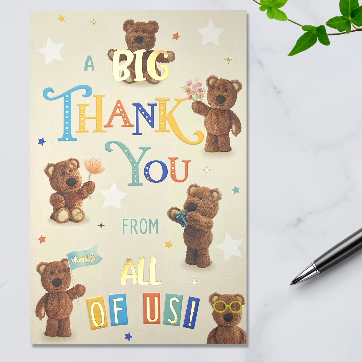 Cream card with Barley Bear character with gifts and text, gold foil details