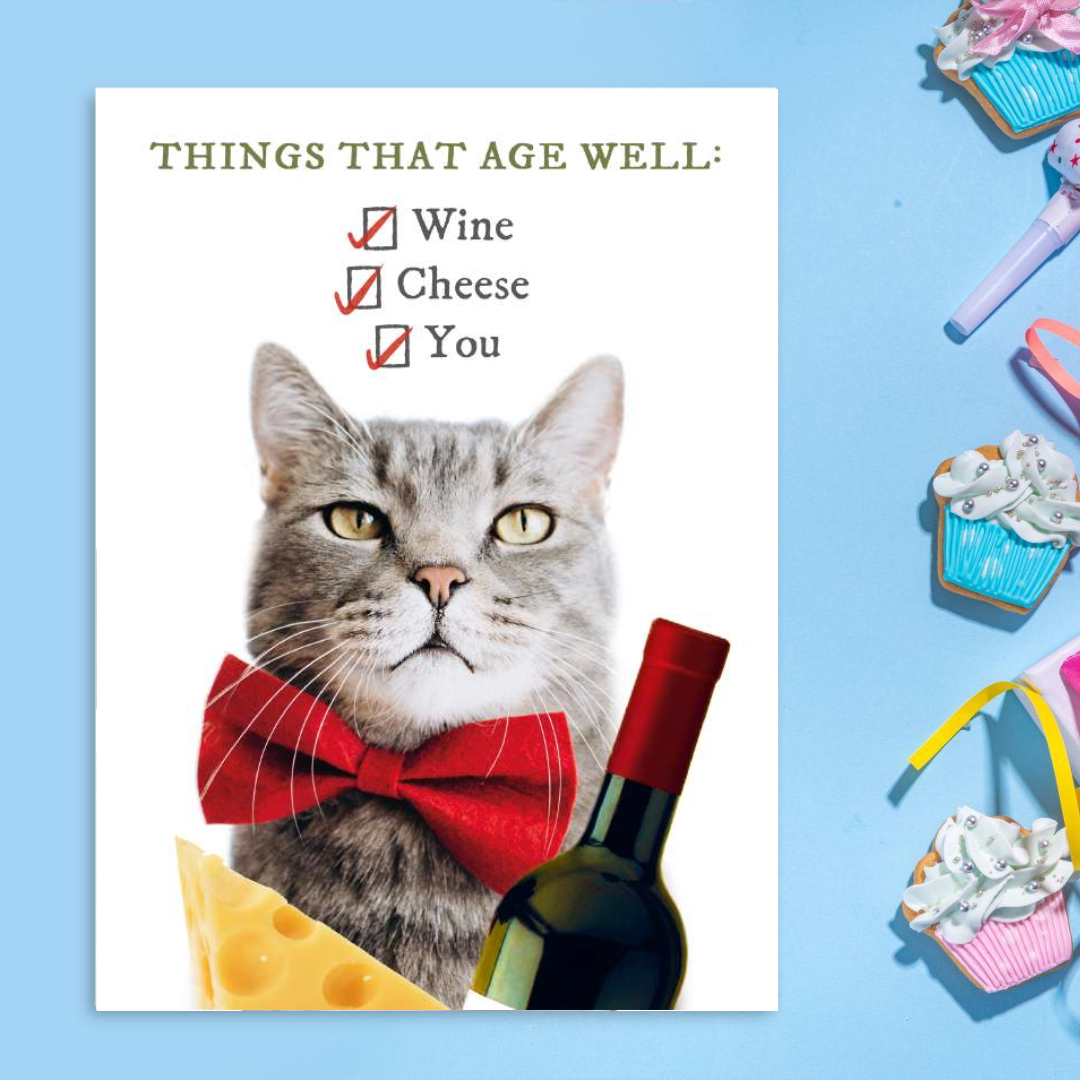 Cat holding a bottle or red wine in a bow tie