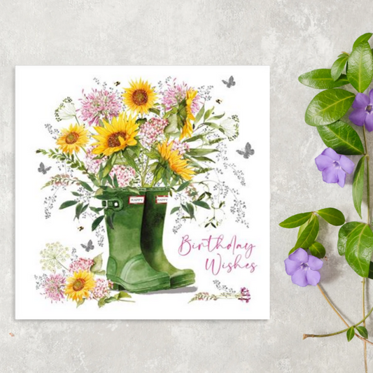 White square card with pair of green wellies filled with sunflowers