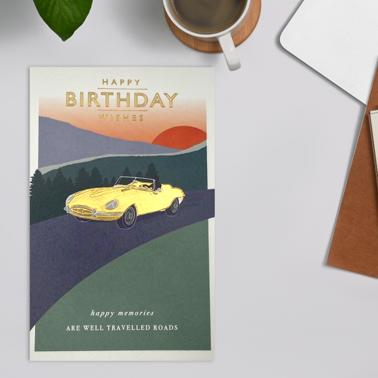 gold foil classic car on country road in front of sunset, with birthday text