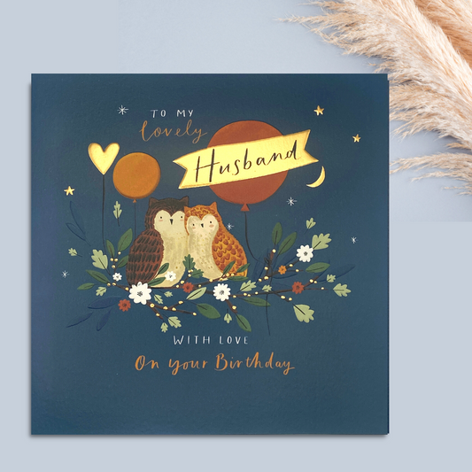 Navy square card with two owls perched on branch with balloon and heart