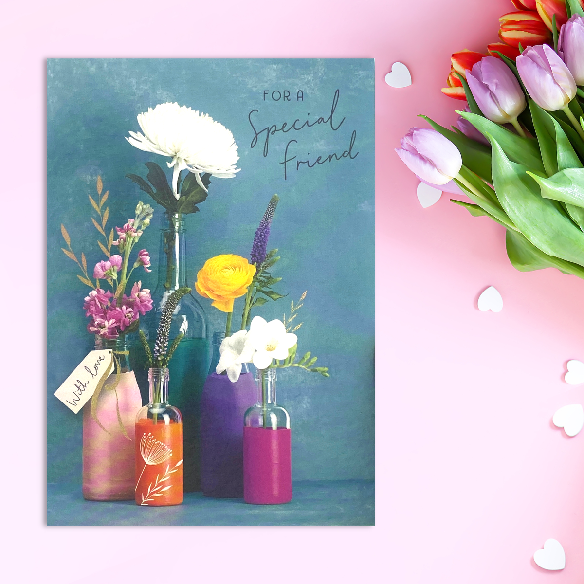 Teal card with colourful bud vases with spring flowers