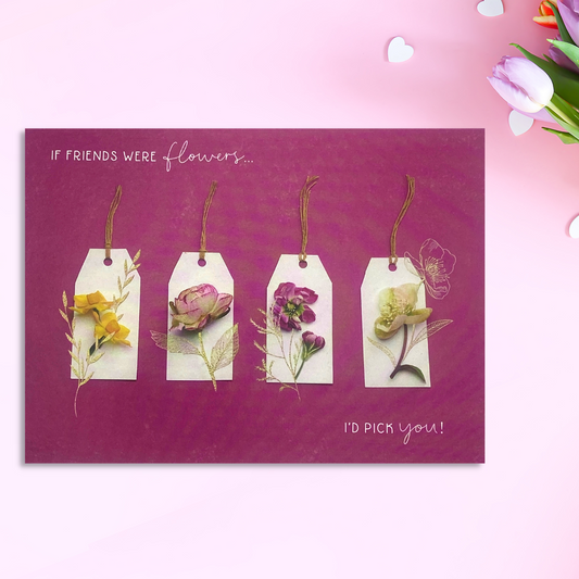 Magenta landscape card with four luggage tags with flowers on laid flat