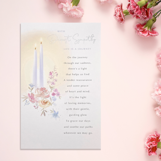White card with two white candles among flowers with heartfelt verse