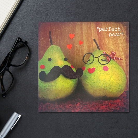 Photographic card with two pears among red hearts