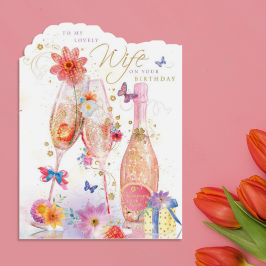 White card with die cut edge and bottle of fizz and flutes design