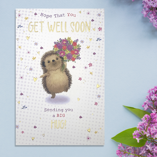 White card with cute hedgehog holding flowers with hearts and floral border