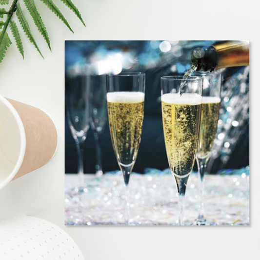 Square card with bubbly being poured into flutes