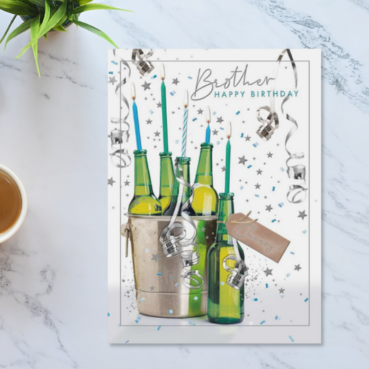 White card with green beer bottles with lit candles in the necks, in beer bucket with streamers