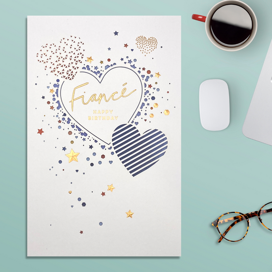 White card with blue laser cut hearts and gold stars