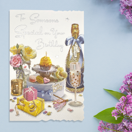 White die cut card with cakes, flowers and fizz display