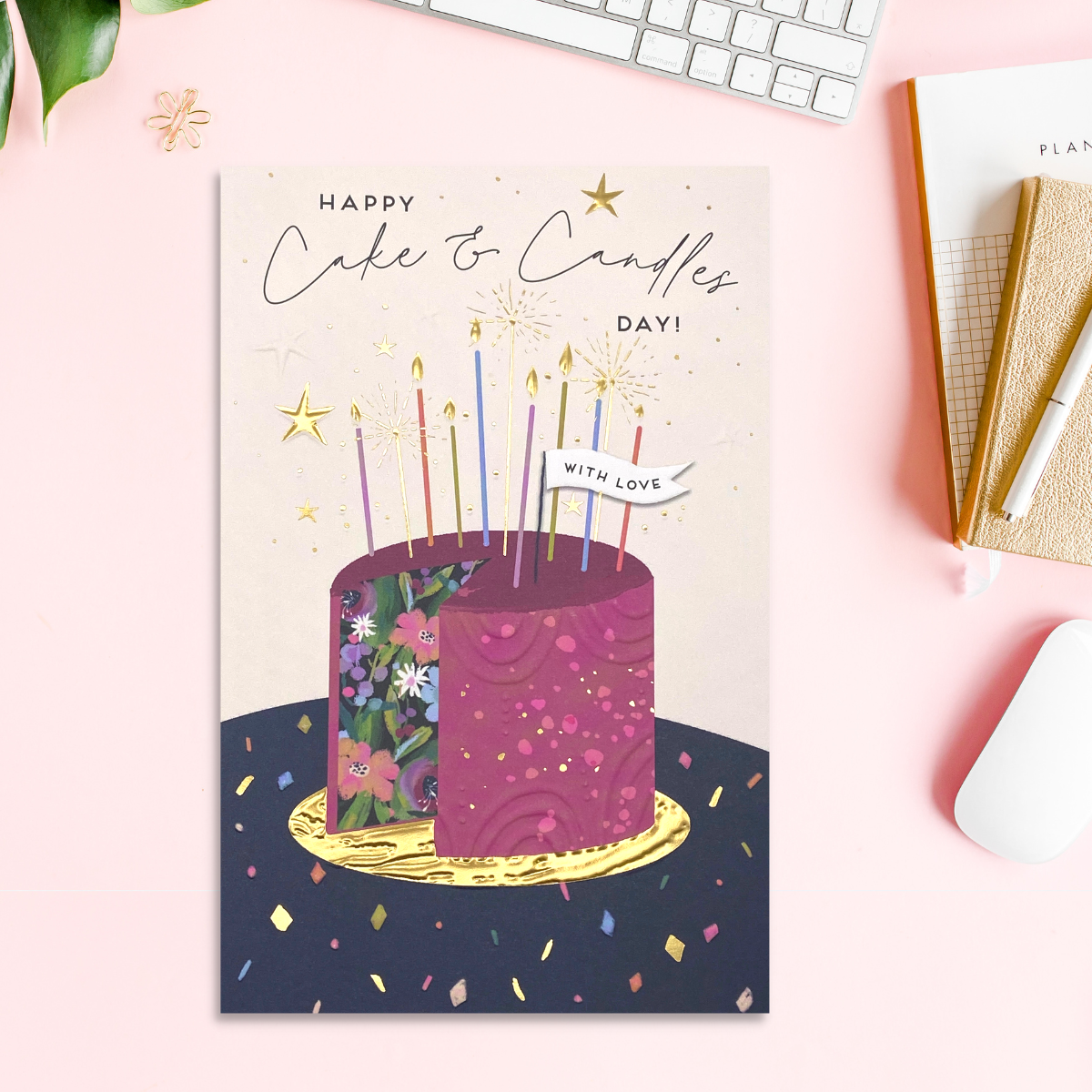 Front image with purple floral cake, candles, confetti and gold foil details