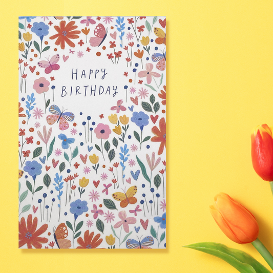 White card with bright coloured spring flowers and embossed finish