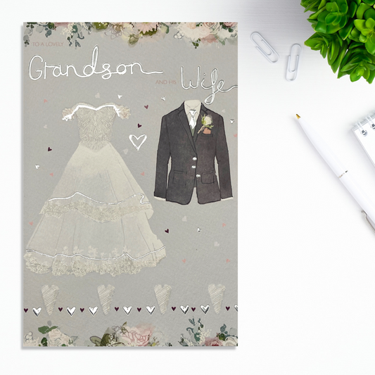 Front image with grey card, suit and wedding dress with silver foil