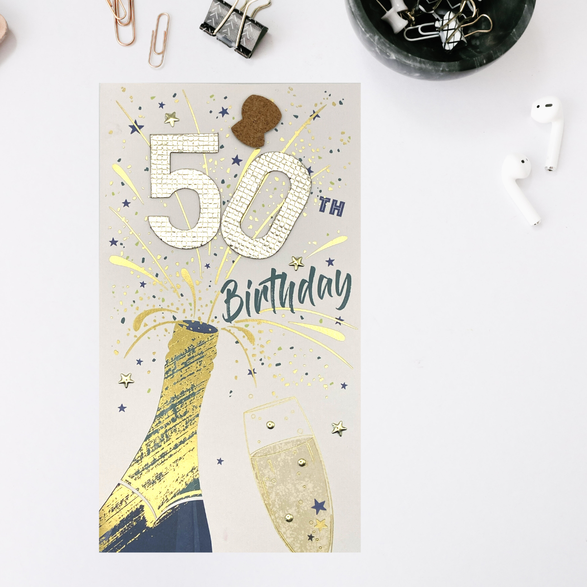 Front image showing champagne bottle popping and large gold decoupage numbers and stars