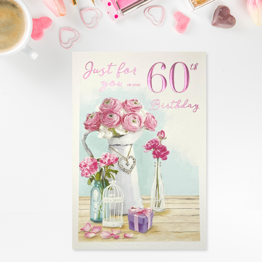 Front card image with floral vases and gift, pink text