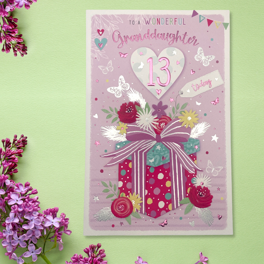 Front image with large Pink and purple gift with flowers and butterflies, age 13 heart and text