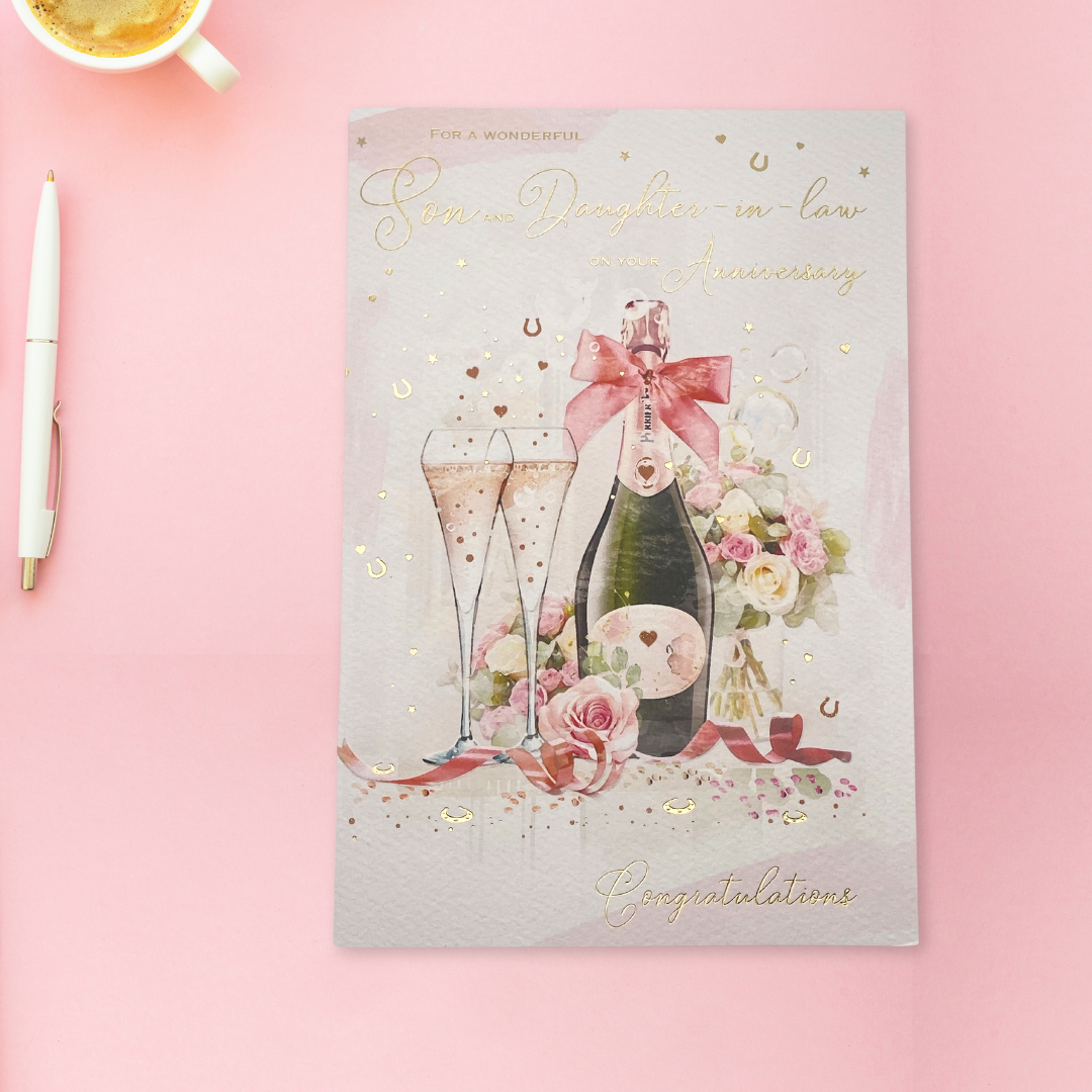 Pink watercolour background with two flutes and champagne & flowers