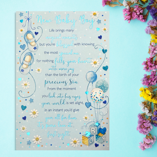 Front image showing blue card with booties, balloons and heartfelt verse