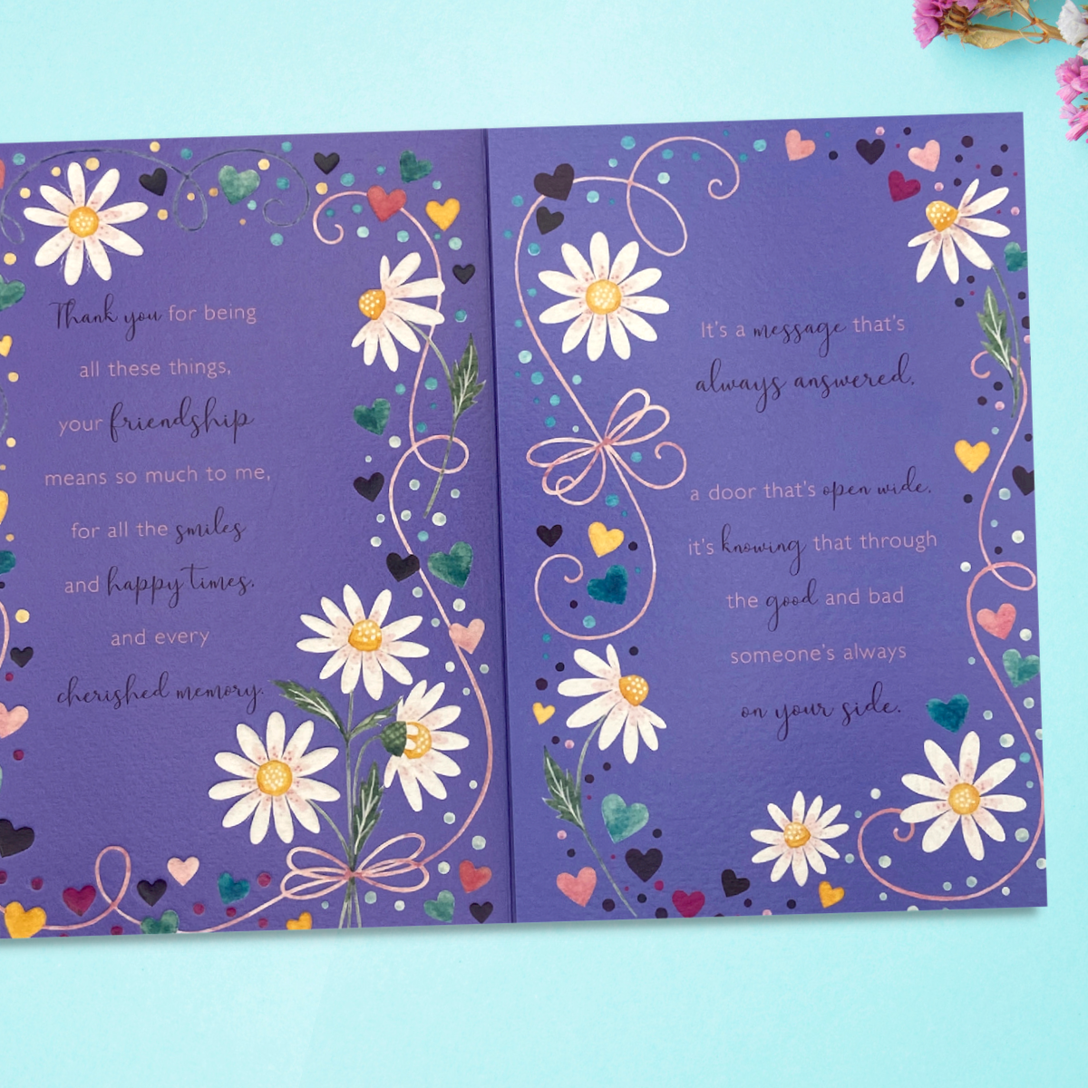 Inside image showing two pages on purple card with flowers and verse