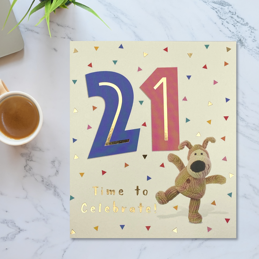 Square cream card with large 21 in pink and blue with colourful triangles and boofle character