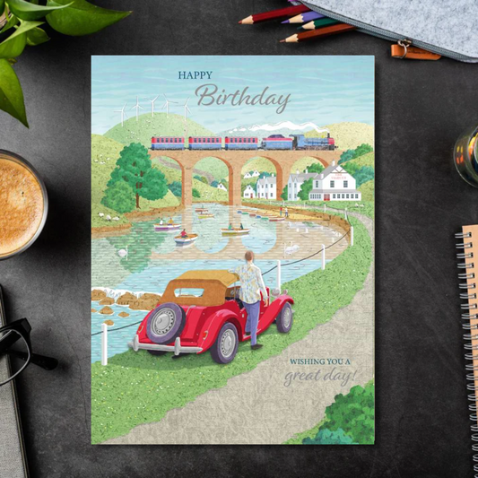Card with red convertible car overlooking viaduct and boats