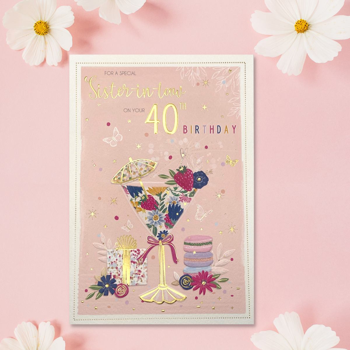 Pink card with cocktail glass with umbrella, flowers and macarons with gift.gold foil text