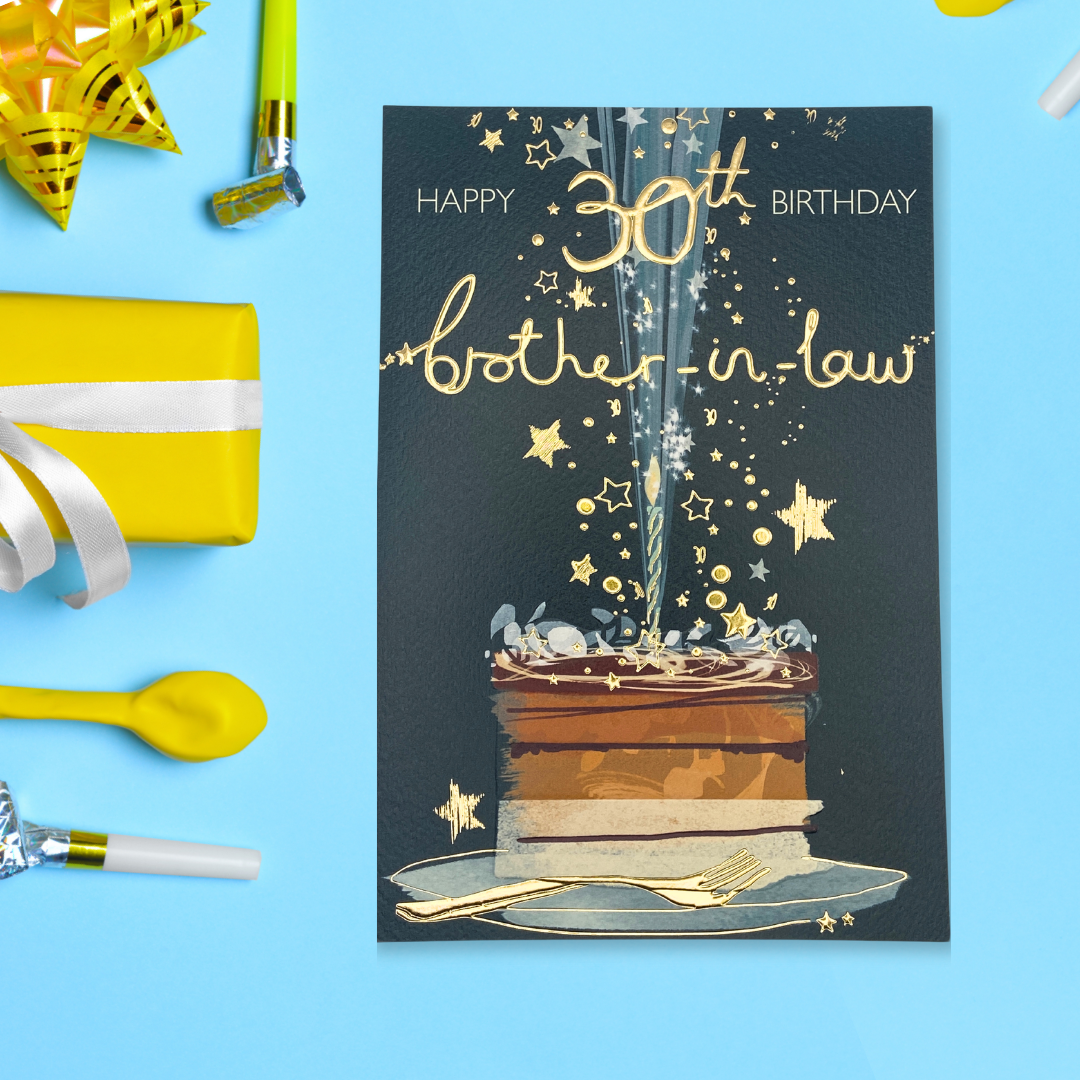 Green card with birthday cake, candles and gold foil text and stars